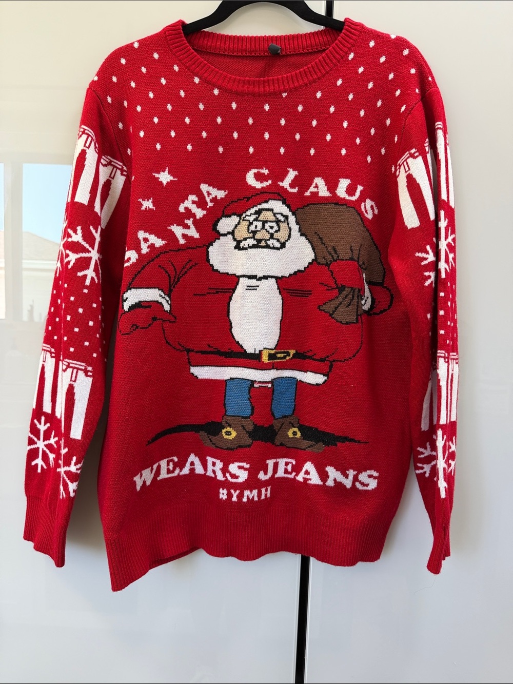 Santa wears jeans Christmas sweater